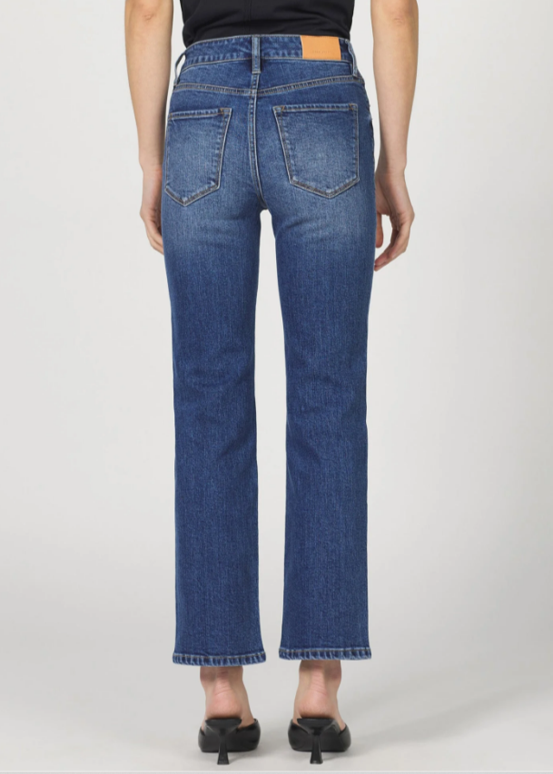 Person wearing blue jeans on a white background