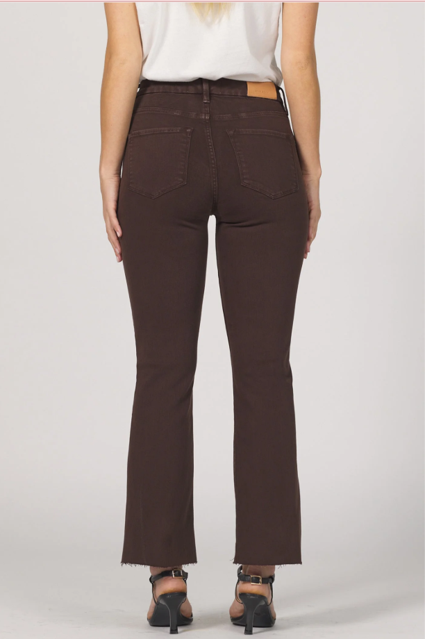 Brown pants worn by a person on a white background