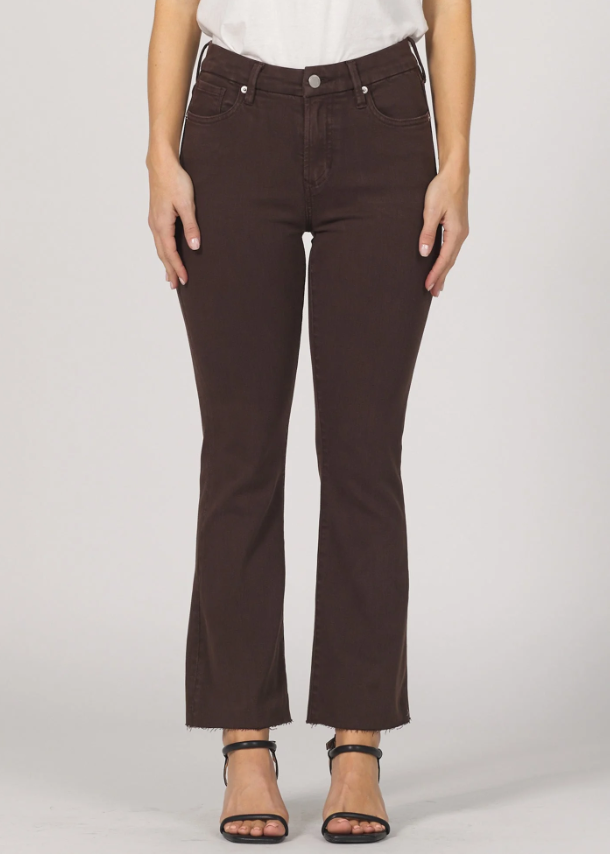 Brown jeans worn by a person on a white background