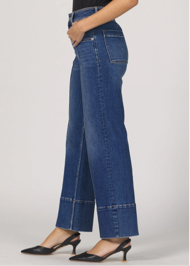Blue jeans worn by a person on a white background