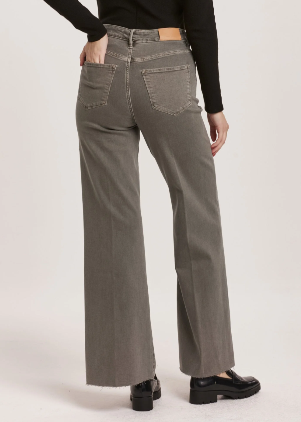 Person wearing high-waisted gray jeans on a white background