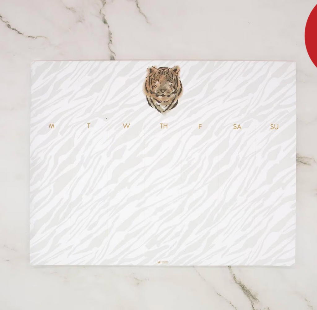 Weekly planner with a tiger design on a marble surface