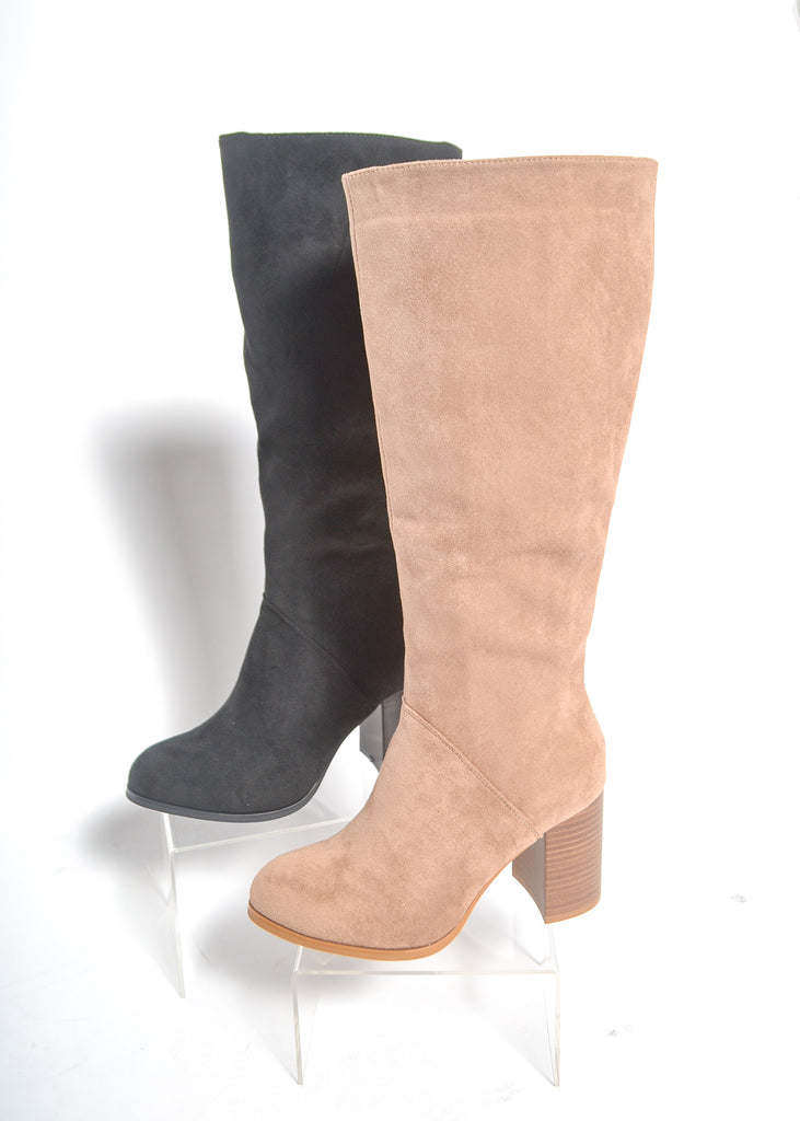 Black and beige knee-high boots on a white background